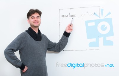 Middle Eastern Teacher Pointing On Whiteboard Stock Photo