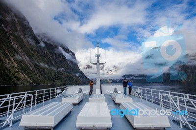 Milfordsound New Zealand-august 30 : Tourist On Roof Of Milfordsound Cruise With High Mountain Background On August30, 2015 In Milford Sound Fiordland National Park New Zealand Stock Photo