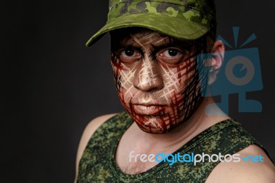 Military Style Camouflage On The Soldier's Face Stock Photo