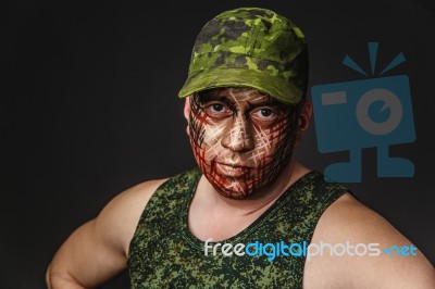 Military Style Camouflage On The Soldier's Face Stock Photo