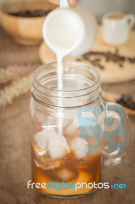 Milk Pouring For Fresh Iced Coffee Stock Photo