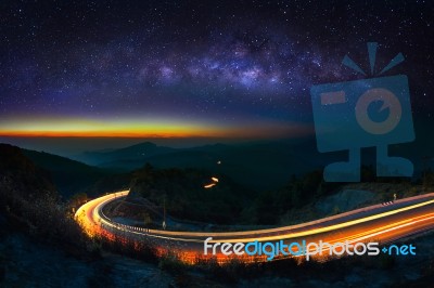 Milky Way And Car Light On Road At Doi Inthanon National Park In The Night, Chiang Mai, Thailand Stock Photo