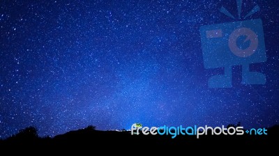 Milky Way And Silhouette Of Tree On Top Of Mountain, Long Exposu… Stock Photo