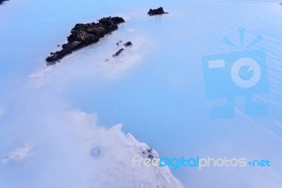 Milky White And Blue Water Between The Lava Stones Covered With Moss Stock Photo