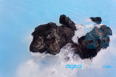 Milky White And Blue Water Between The Lava Stones Covered With Moss Stock Photo