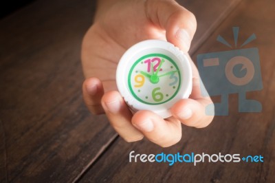 Mini White Clock In Hand Stock Photo