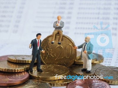 Miniature Businessman Stand On Euro Coins And Book Bank. Busines… Stock Photo