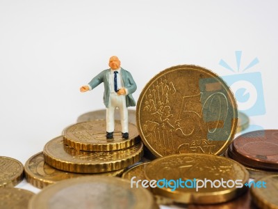 Miniature Businessman Stand On Euro Coins And Book Bank. Busines… Stock Photo