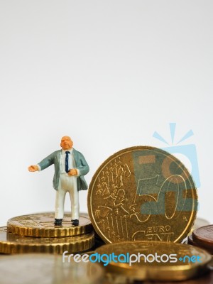 Miniature Businessman Stand On Euro Coins And Book Bank. Busines… Stock Photo