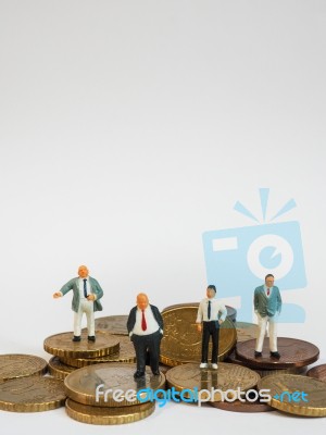 Miniature Businessman Stand On Euro Coins And Book Bank. Busines… Stock Photo