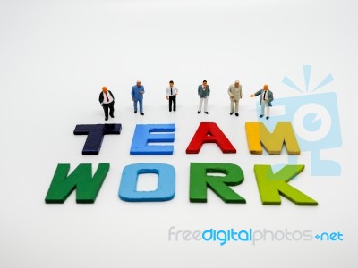 Miniature Bussinessman With Teamwork Word Letters On White Backg… Stock Photo