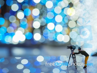 Miniature Camera Man With Beautiful Light Bokeh Background. Chri… Stock Photo