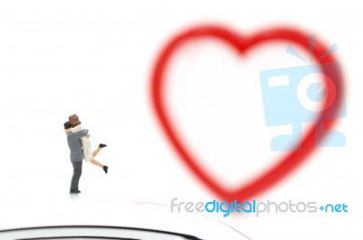 Miniature Couple Hugging And Red Heart On White Background, Stock Photo