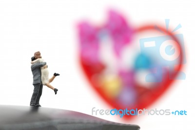 Miniature Couple Hugging And Red Heart On White Background, Stock Photo