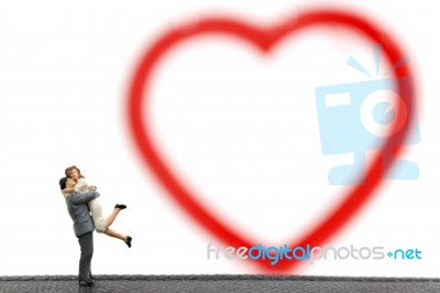 Miniature Couple Hugging On White Background Stock Photo