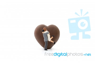 Miniature Couple Hugging On White Background Stock Photo