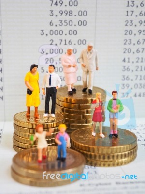 Miniature Family Stand On Pile Of Euro Coins And Book Bank. Fami… Stock Photo