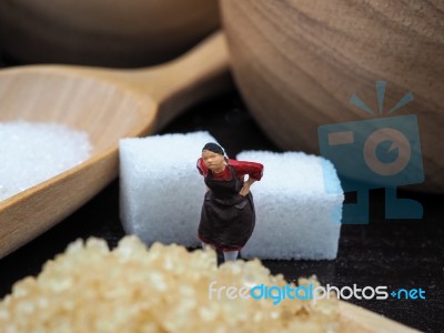 Miniature Fat Woman Standing Near Wooden Bowl And Spoon With Sug… Stock Photo