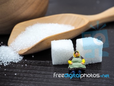 Miniature Fat Woman Standing Near Wooden Bowl And Spoon With Sug… Stock Photo