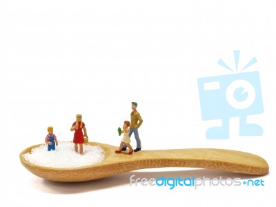 Miniature Little Children Standing On A Wooden Spoon And Thinking Of Sugar, Diet, Fat And Diabetes. Health Care Concept Stock Photo