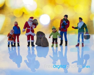 Miniature Santa Claus And Family With Beautiful Light Bokeh Back… Stock Photo