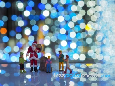 Miniature Santa Claus And Family With Beautiful Light Bokeh Back… Stock Photo