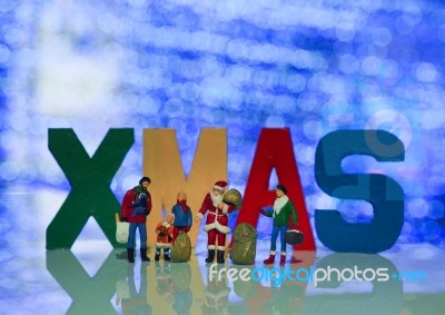 Miniature Santa Claus And Family With Beautiful Light Bokeh Back… Stock Photo