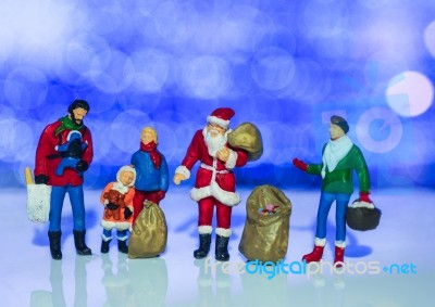 Miniature Santa Claus And Family With Beautiful Light Bokeh Back… Stock Photo