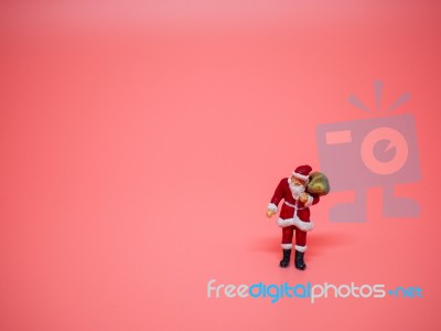 Miniature Santa Claus On Pink Background. Christmas And Happy Ne… Stock Photo