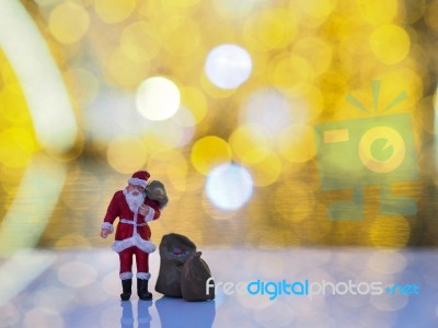 Miniature Santa Claus With Beautiful Light Bokeh Background. Chr… Stock Photo