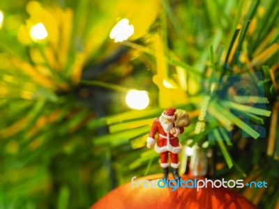 Miniature Santa Claus With Beautiful Light Bokeh Background. Chr… Stock Photo