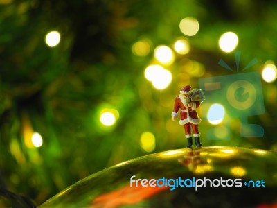 Miniature Santa Claus With Beautiful Light Bokeh Background. Chr… Stock Photo