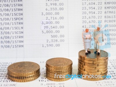 Miniature Senior Couple Stand On Pile Of Euro Coins. Retirement Stock Photo