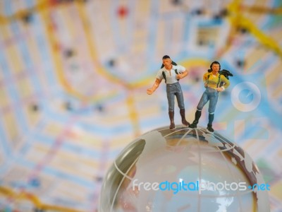 Miniature Traveller Or Backpacker Stand On Globe Of Glass And Ma… Stock Photo