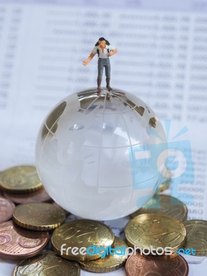 Miniature Traveller Or Backpacker Stand On Globe Of Glass, Euro Stock Photo