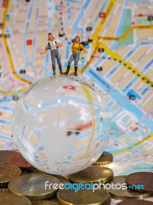 Miniature Traveller Or Backpacker Stand On Globe Of Glass, Euro Stock Photo