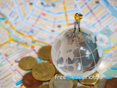 Miniature Traveller Or Backpacker Stand On Globe Of Glass, Euro Stock Photo