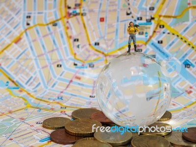 Miniature Traveller Or Backpacker Stand On Globe Of Glass, Euro Stock Photo