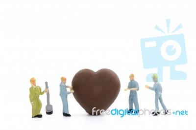 Miniature Worker Making Heart Shaped Chocolate On White Background , Stock Photo