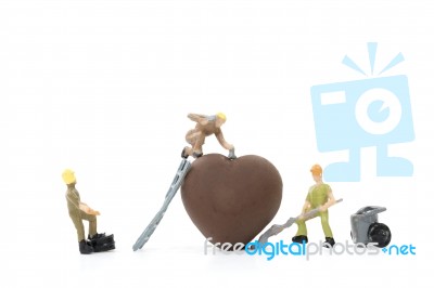 Miniature Worker Making Heart Shaped Chocolate On White Background , Stock Photo