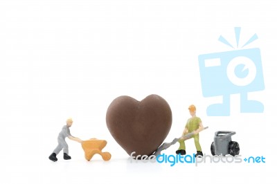 Miniature Worker Making Heart Shaped Chocolate On White Background , Stock Photo