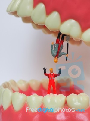 Miniature Worker On Plastic Teeth Of Removable Denture. Dental H… Stock Photo