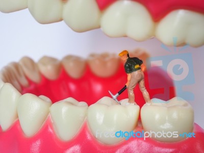 Miniature Worker On Plastic Teeth Of Removable Denture. Dental H… Stock Photo