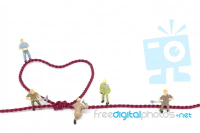 Miniature Worker Team Building Heart Shaped With Rope Stock Photo