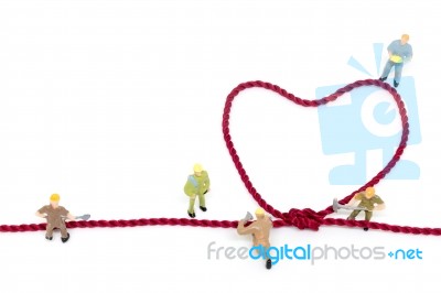 Miniature Worker Team Building Heart Shaped With Rope Stock Photo