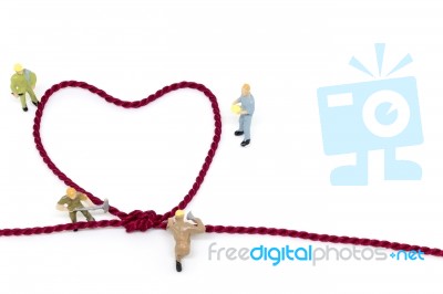 Miniature Worker Team Building Heart Shaped With Rope Stock Photo