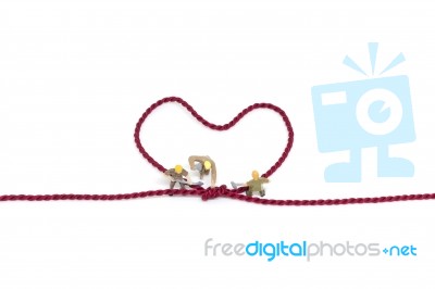 Miniature Worker Team Building Heart Shaped With Rope Stock Photo