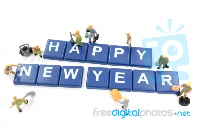 Miniature Worker Team Building Word Happy New Year On White Back… Stock Photo