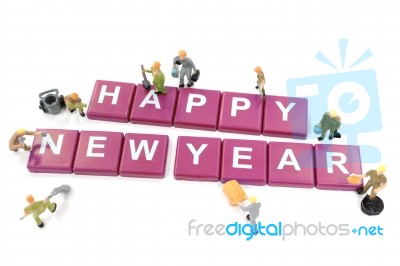 Miniature Worker Team Building Word Happy New Year On White Back… Stock Photo