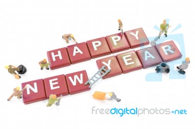 Miniature Worker Team Building Word Happy New Year On White Background Stock Photo